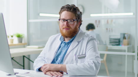 portrait of male practitioner at work in medical office