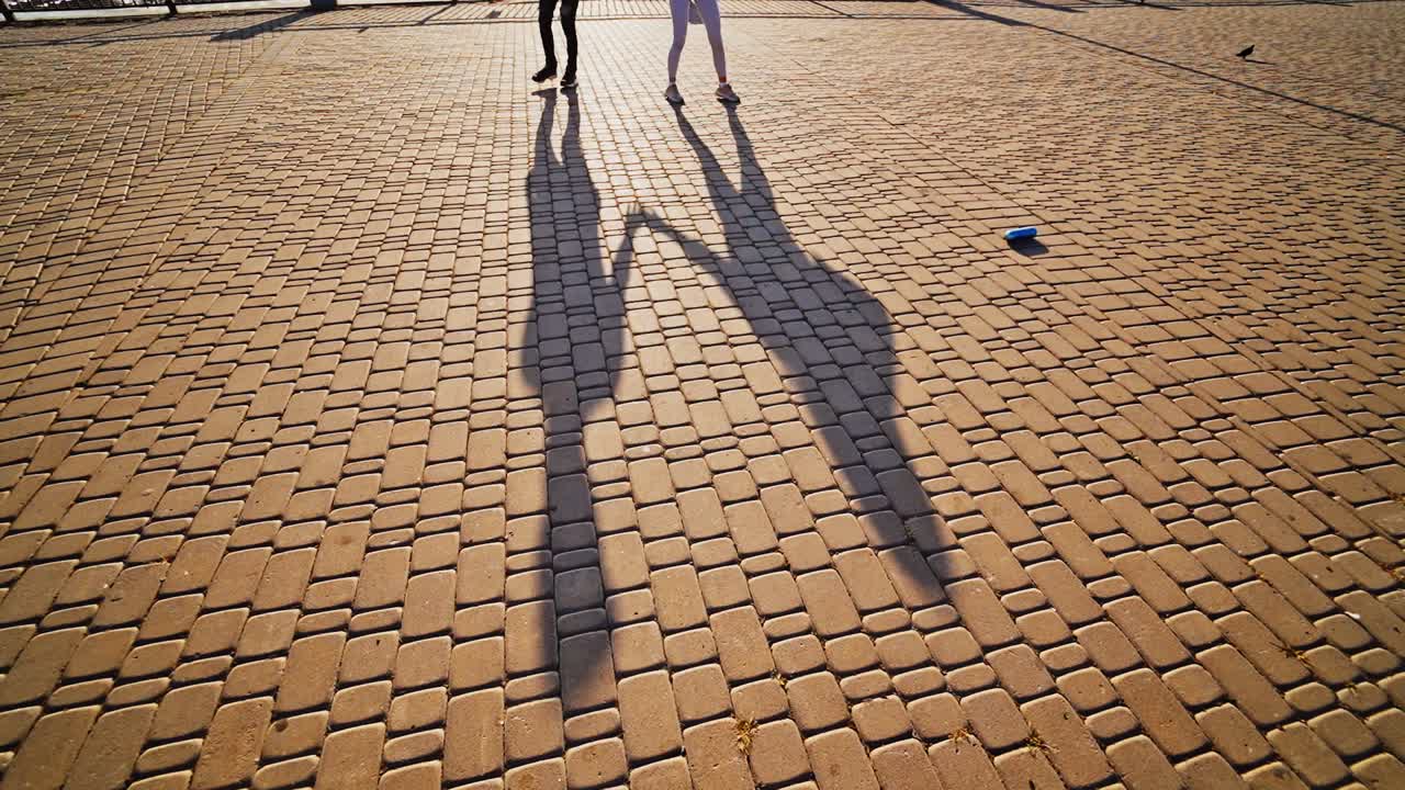 Couple dancing in the street. Close up view of couple dancing feet in city