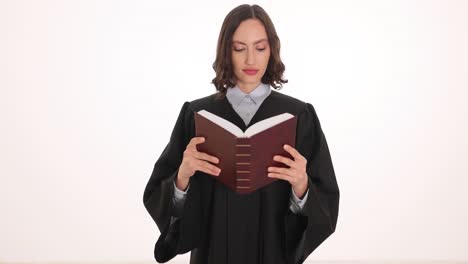 woman in judicial robe reading a book