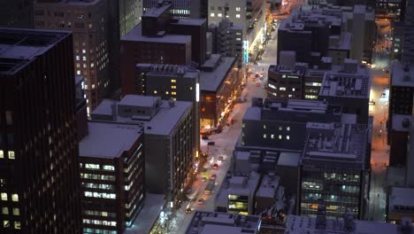 close up shot of urban city with snowed in roads at night