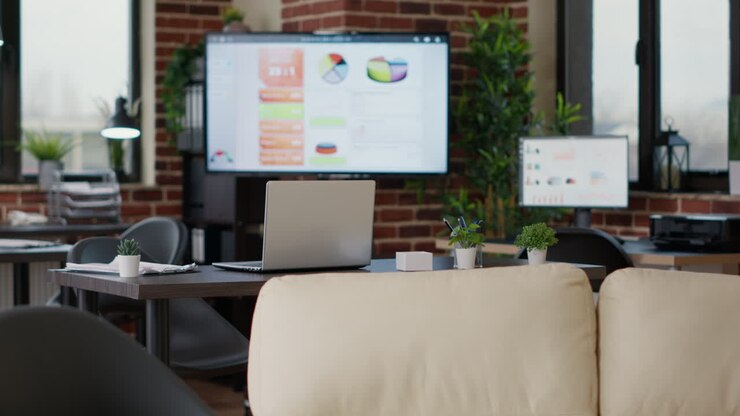 No people in empty company office with desks and laptops