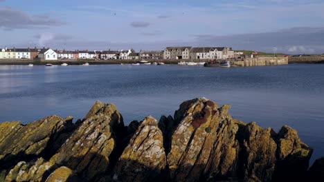 A-view-of-the-small-Scottish-village-of-Isle-of-Whithorn-in-Dumfries-and-Galloway-with-small-boats-anchored-in-the-harbour