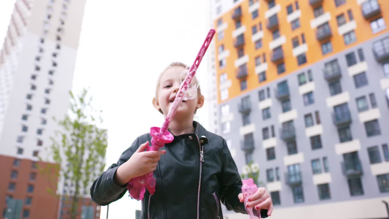 Little Girl Blowing Bubbles in the City