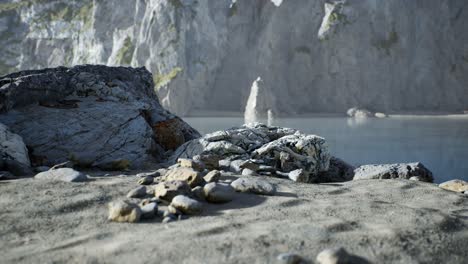 sand beach among rocks at atlantic ocean coast in portugal