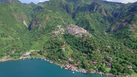 drone aerial footage of volcanic lakeside indigenous town santa cruz la laguna, guatemala in lake atitlan in central america highlands