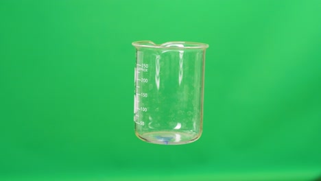 empty beaker on green background