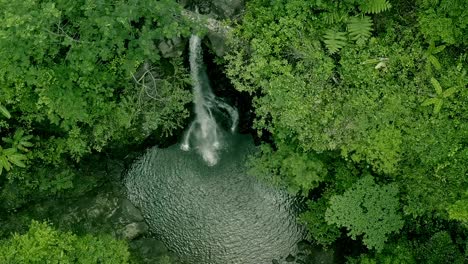 Cinematic-aerial-view-of-Lumondo-waterfalls-hidden-deep-in-the-jungles-of-Alegria,-Surigao-del-Norte,-Philippines