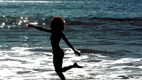 woman dancing while she is into the sea