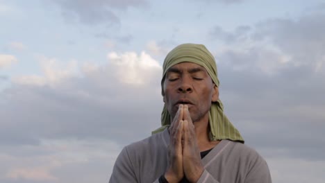 black-man-praying-to-god-Caribbean-man-praying-with-blue-sky-in-the-background-stock-video