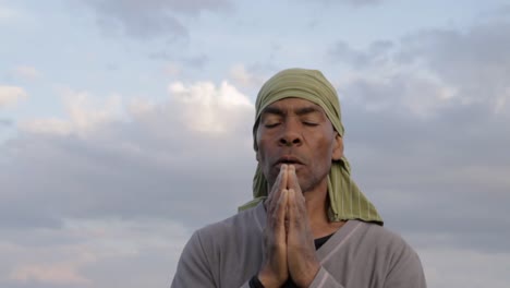 black man praying to god caribbean man praying with blue sky in the background stock video