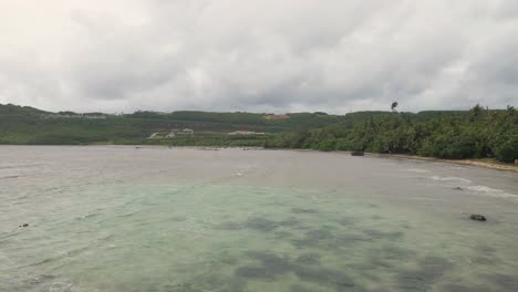 panning over a tropical island bay during the beginning of a typhoon
