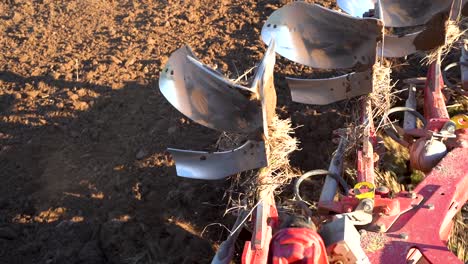 Heavy-machinery-plowing-soil-before-planting-seeds,-view-from-cabin