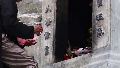 man performing ritual at a shrine