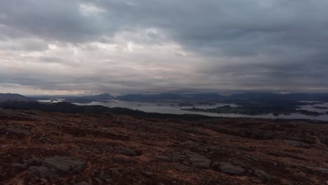 Leroyosen-waters-and-Flesland-Bergen-airport-in-the-background---Late-night-moody-cloudy-aerial-close-to-ground