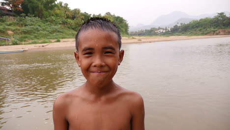 smiling boy by the river