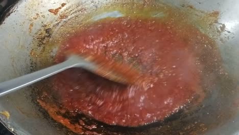 sambal tumis or stir-fried chilli paste is a versatile malay and indonesian condiment in the hot pan which is used for cooking spicy dishes such as added with prawns, egg and stinky beans.