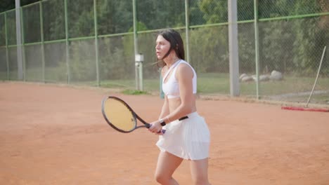 female tennis player practicing serve on outdoor court