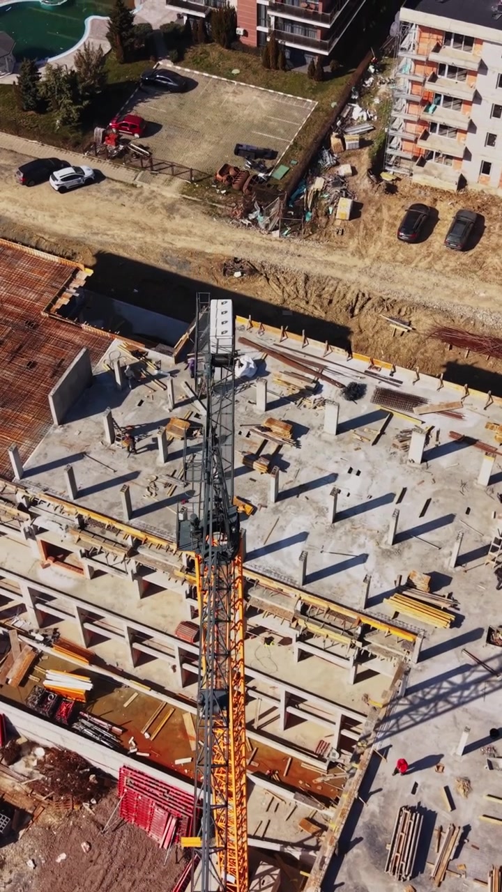 High aerial view of construction site with tower crane