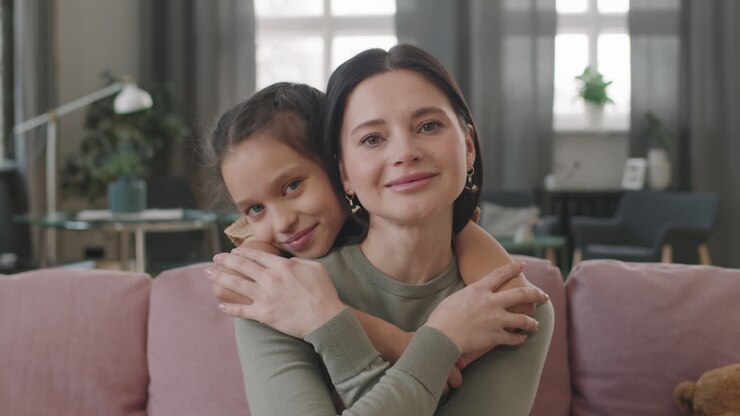 A mother and daughter embrace each other