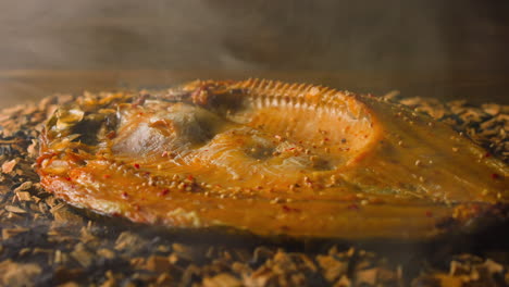 cooking smoked ide fish with seasonings on decayed shavings