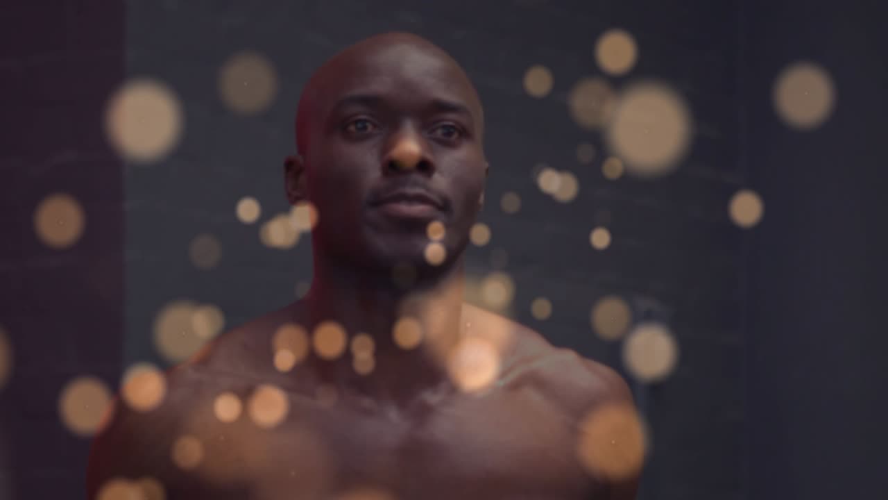 Mid-adult man holding pose and initiating jump-rope skipping for fitness in studio with bokeh layer