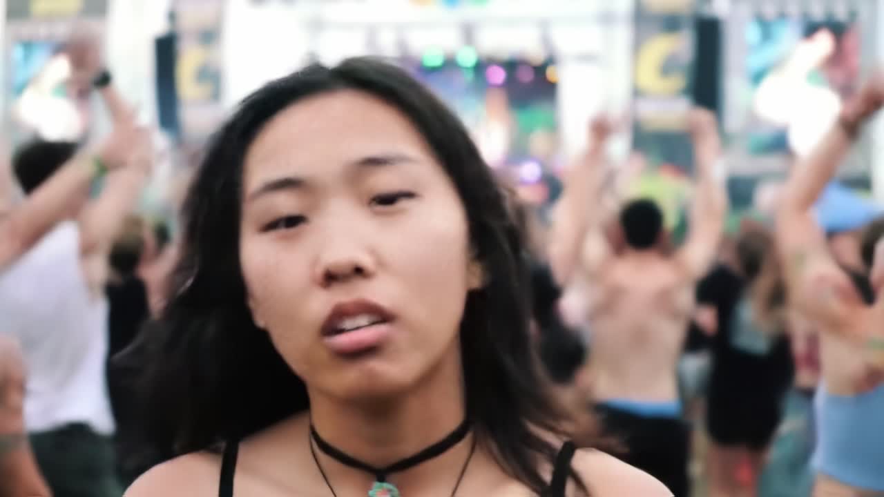 An inspiring moment at a lively music festival as the sun sets, showcasing the emotional connection of the crowd. People are immersed in the experience, celebrating together.