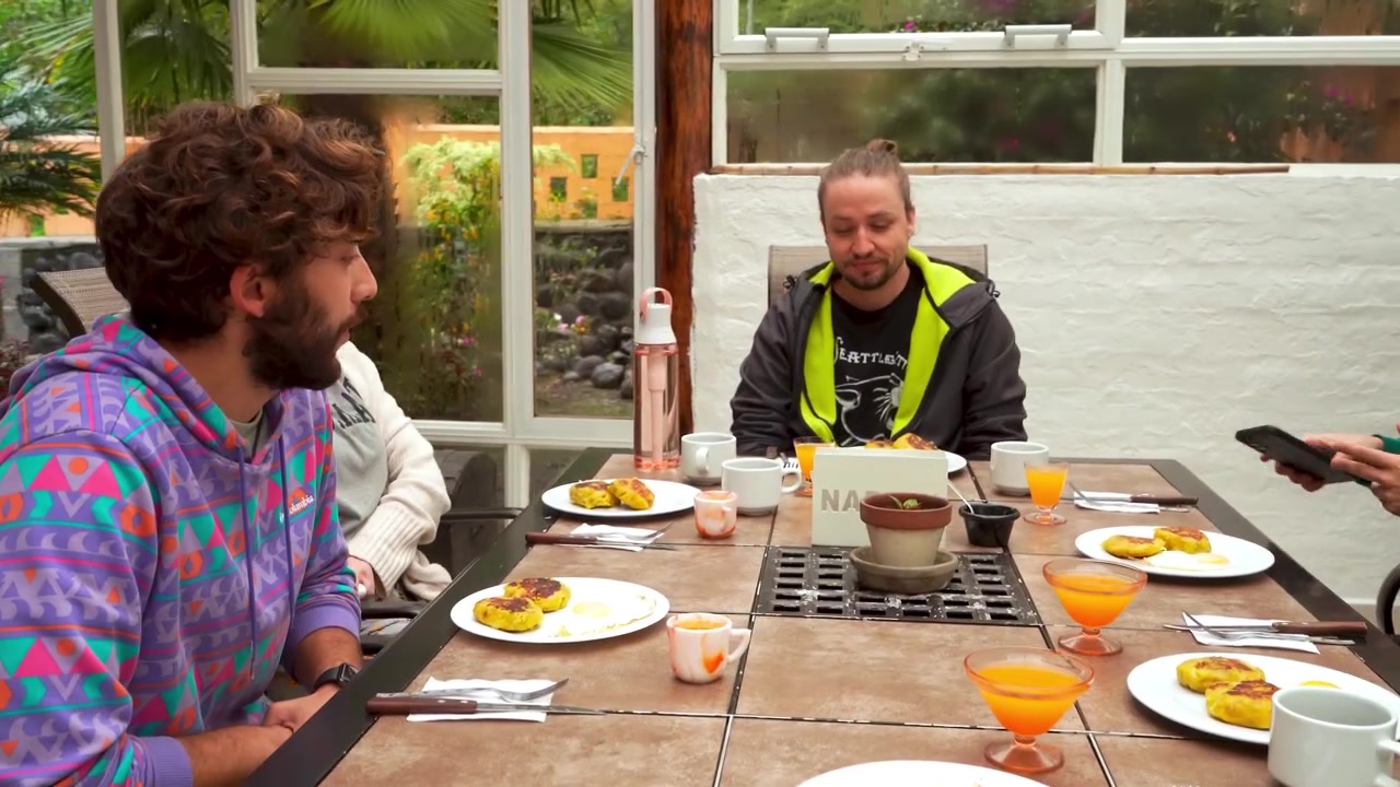 Group of friends ready to eat traditional plantain breakfast with juice. Bright natural light and casual ambiance. Great for lifestyle, food culture, or social connection themes.