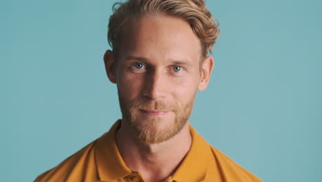 Blue eyes man looking at front and smiling slightly