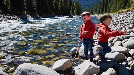 two boys playing by a river
