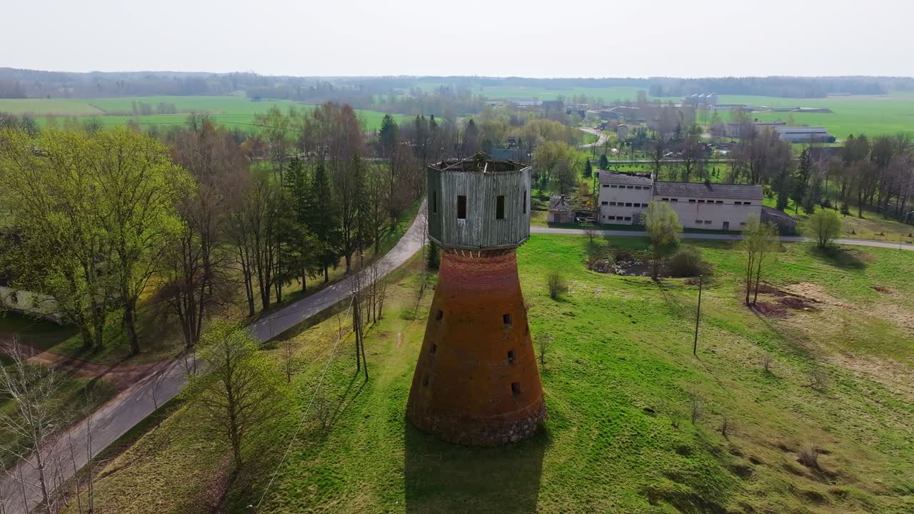 Zdjęcia lotnicze ukazują krajobraz z wieżą Iles Mill, wykonane z drona oddalającego się wiosną