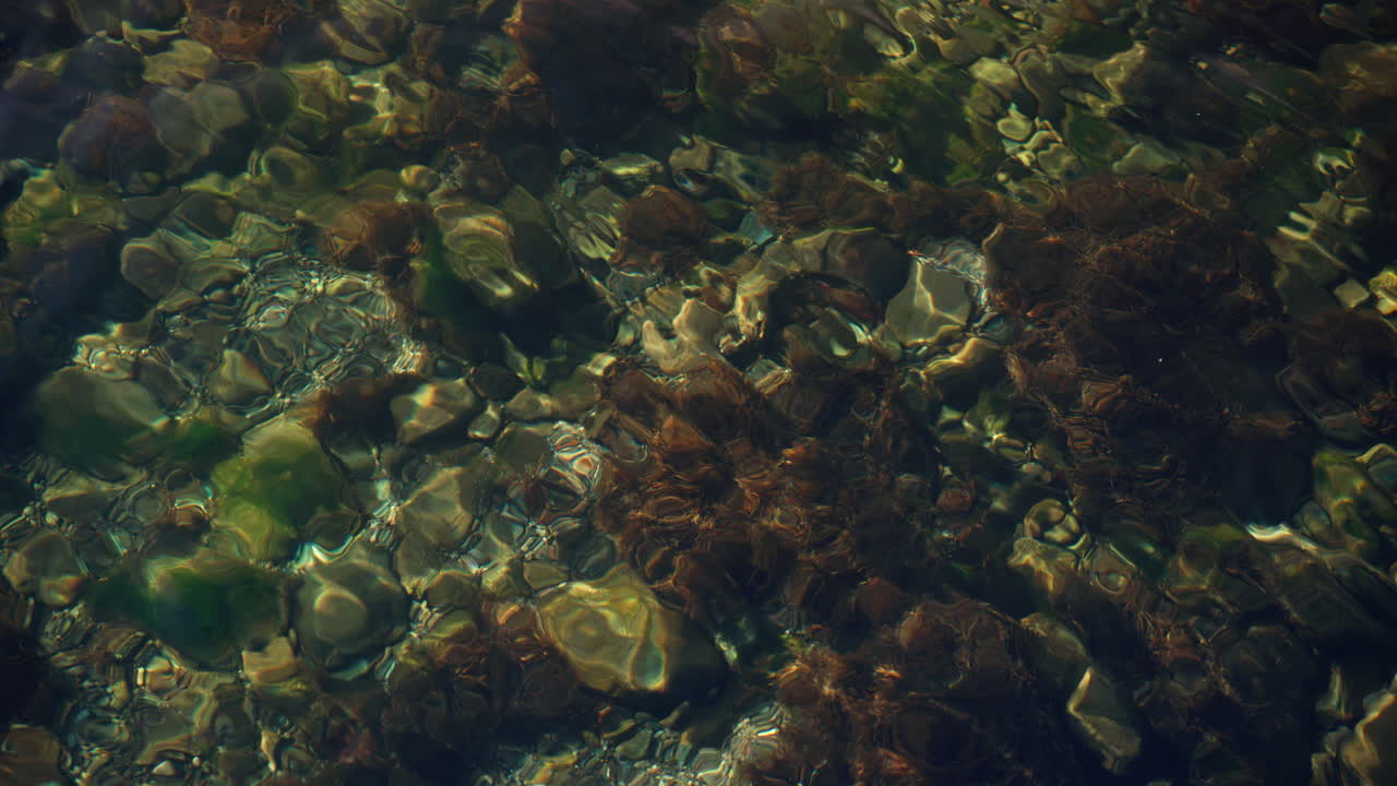 Water flows and the water is so clear that you can see the rocks at the bottom
