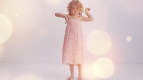 small girl dancing against a white wall