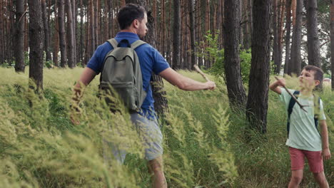 man and child playing in the forest