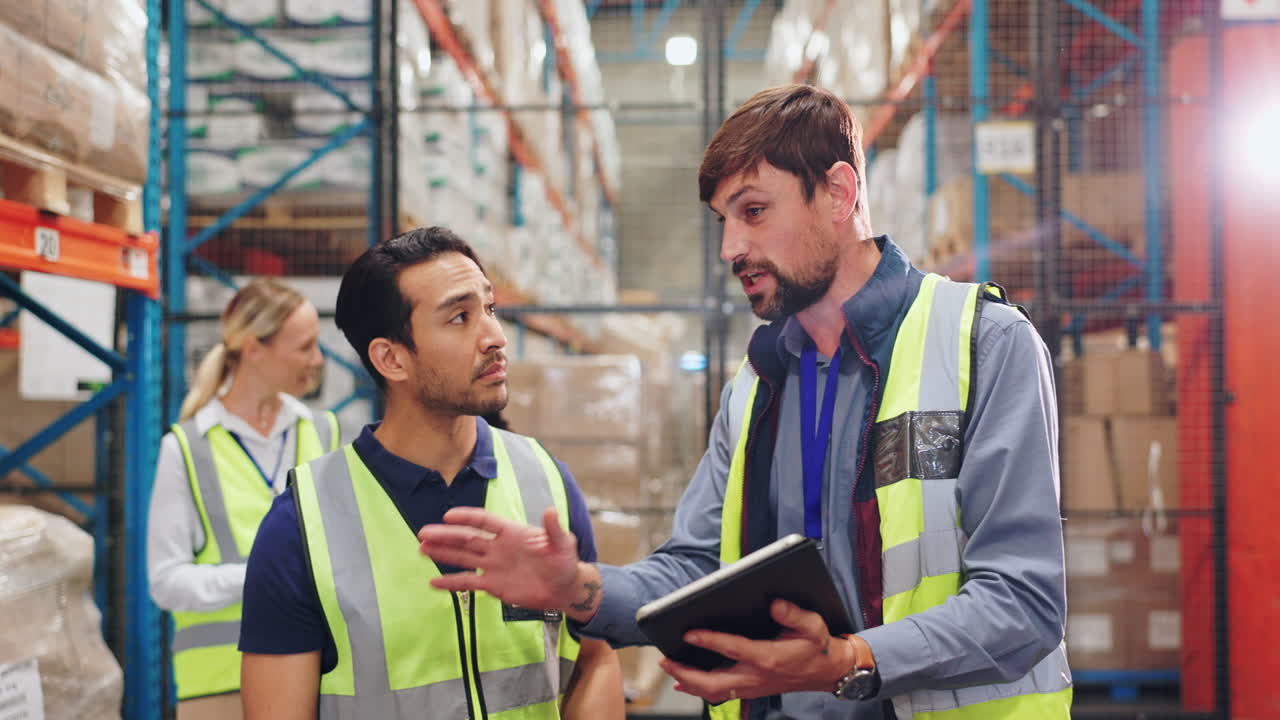 Warehouse employees discussing inventory