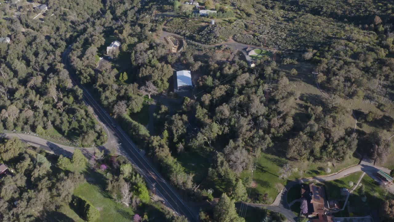 Glowing aerial of farm land trees in the mountains during a beautiful sunrise