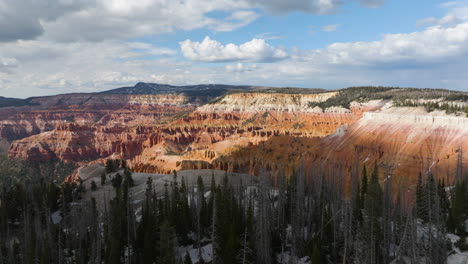 drone shot over forest, revealing a canyon full of pillars of erosion rock, in utah, usa