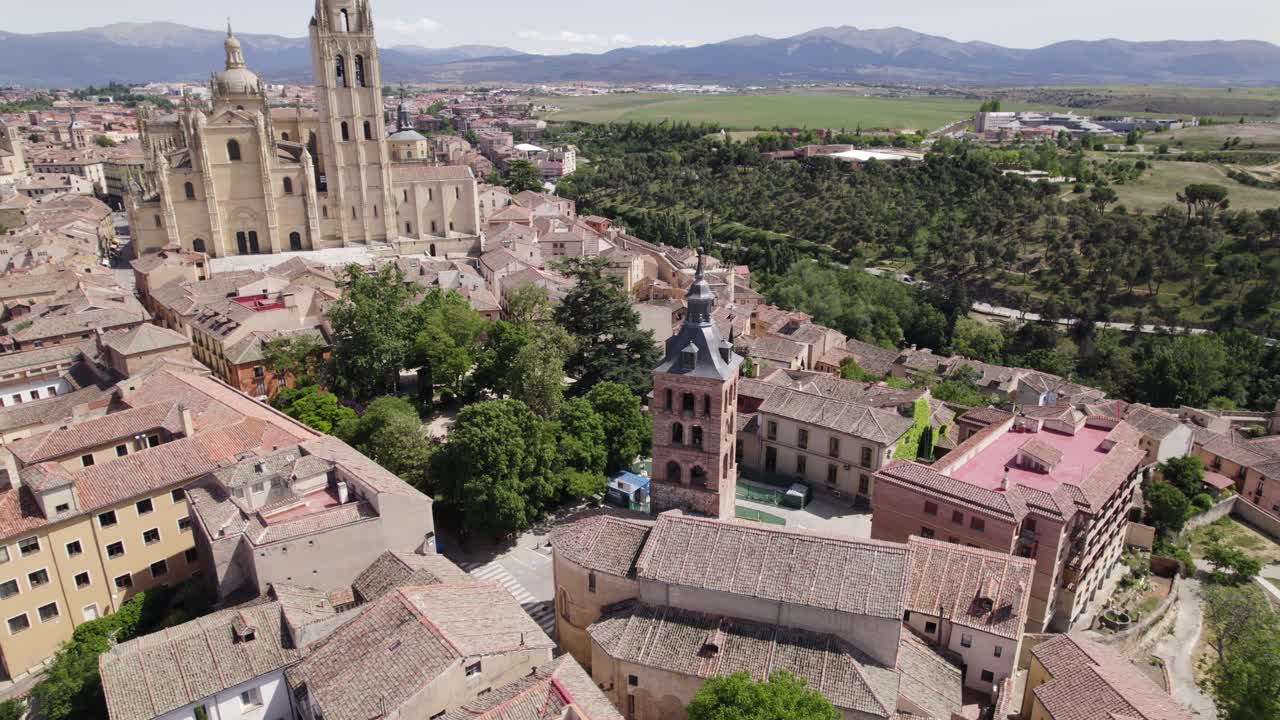 Segovia's Aerial: Iglesia de San Esteban and Segovia Cathedral amidst cityscape
