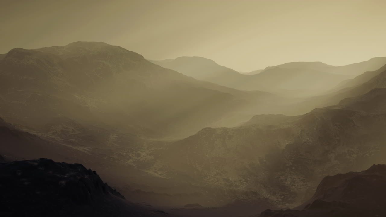 Serene mountain landscape enveloped in mist at dawn during early morning hours