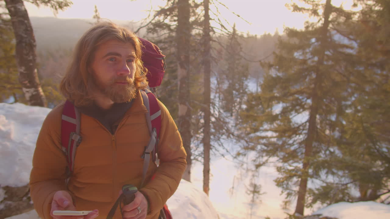 Man Using Map on Smartphone during Winter Hike