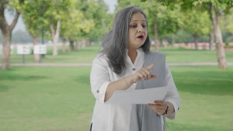 Old-Indian-woman-discussing-reports-in-park