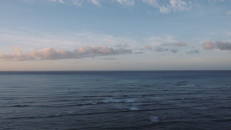 Surfistas-Temprano-En-La-Mañana-Montando-Las-Olas-En-La-Bahía-De-Waikiki,-El-Horizonte-Costero-Y-El-Colorido-Amanecer,-Hawaii