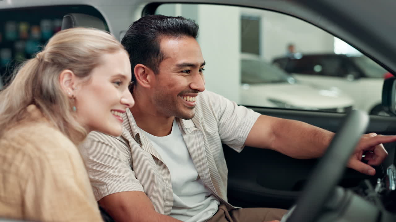 Couple inside a car at a dealership