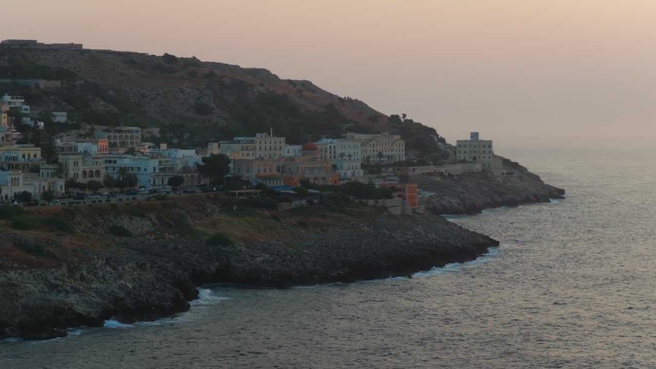 Santa Cesarea Terme on rugged coastline at sunrise, Puglia, Italy. Aerial drone lateral view