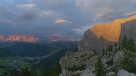 Awesome-illuminated-South-Tyrol-rocky-mountain-landscape-aerial-reverse-view-of-sunset-glowing-on-rugged-peaks