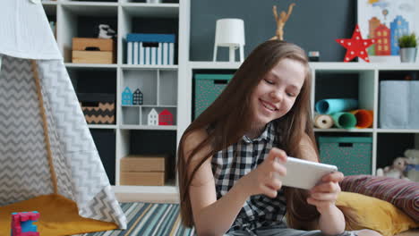 girl playing a mobile game in a playroom
