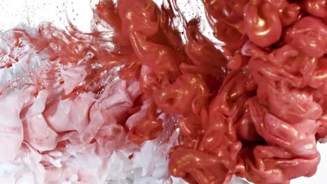 white and red gold ink in water