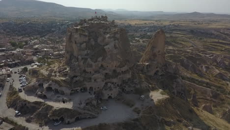 orbiting aerial of uchisar castle, natural cave tower in cappadocia
