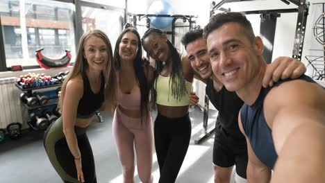 happy fitness group selfie in gym