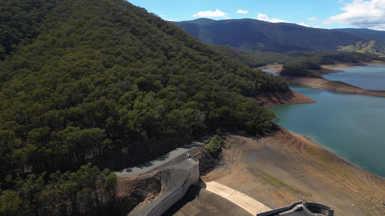 Reversing aerial views over the Blowering Dam, spillway and Reservoir, New South Wales alpine region.