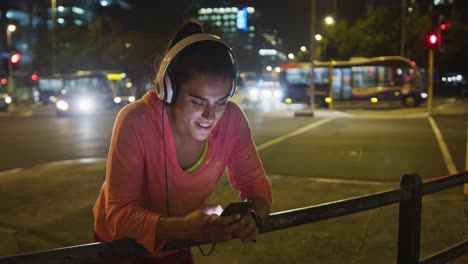 young woman listening to music before running